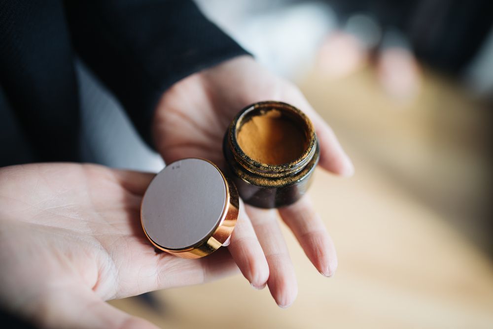 Compact skincare jar, representing ORA International's skincare formulations