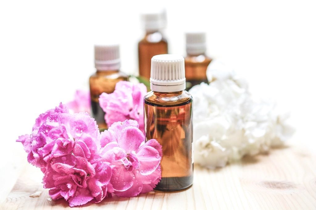 Amber dropper bottles and botanicals styled as a skincare flat lay